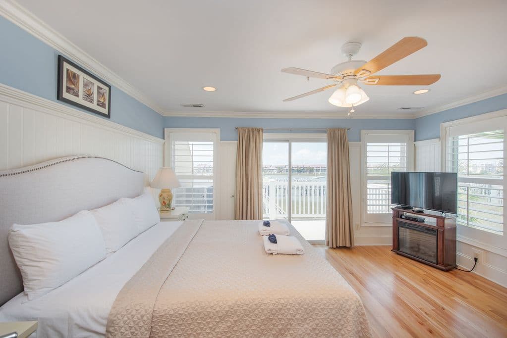 Primary bedroom with balcony and river views